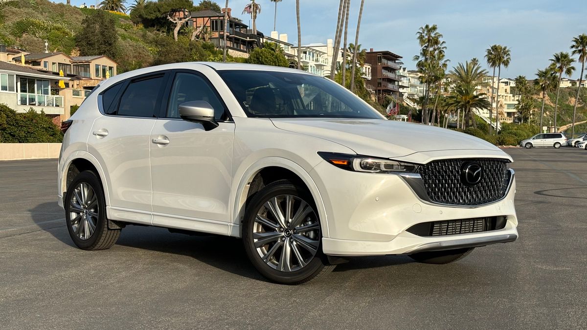 2024 Mazda CX-5 Signature in white in a beach parking lot.