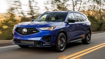 2024 Acura MDX Type S in blue driving down a road.