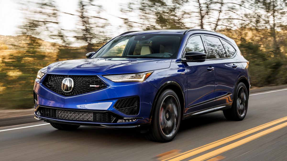 2024 Acura MDX Type S in blue driving down a road.