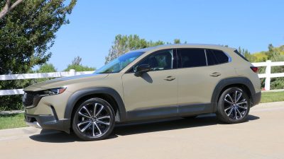 2024 Mazda CX-50 next to a white fence.