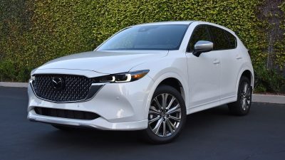 2024 Mazda CX-5 Signature in white with an ivy wall in the background.