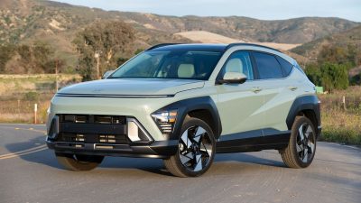 2024 Hyundai Kona Limited in Mirage Green with hills in the background.