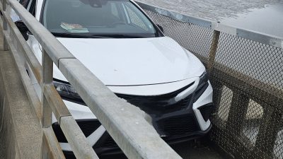 Toyota Camry, stuck on a pedestrian bridge