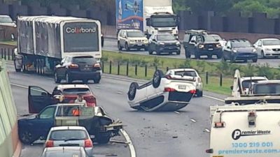 Driver injured as SUV crashes into stolen ute, then flips onto roof on Peninsula Link in Frankston North