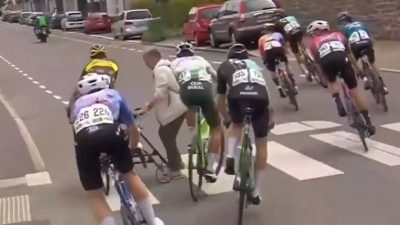 breakaway group narrowly avoids hitting woman zebra crossing rund um koln.png