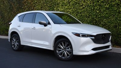 2024 Mazda CX-5 Signature in white with an ivy wall in the background.